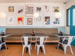 Eggs Up Grill interior wall with artwork
